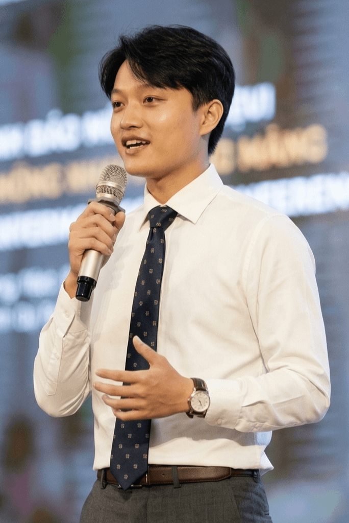 Ryan Nguyen speaking on stage with a microphone